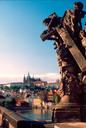 Sunset colors over Charles Bridge statue and Prague Castle.